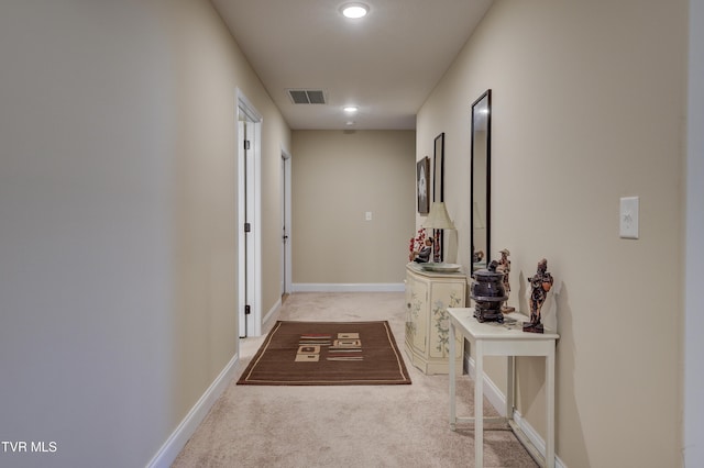 hallway featuring light carpet