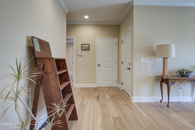 hall with crown molding and light wood-type flooring