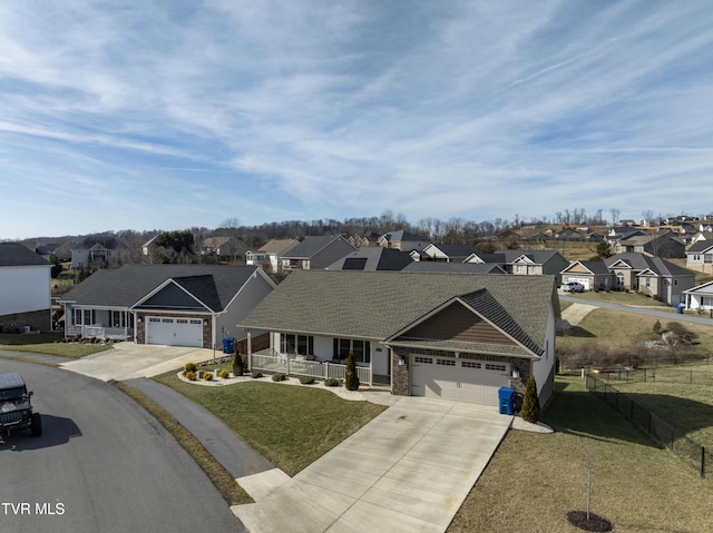 view of front of home with a garage, a front lawn, and a porch