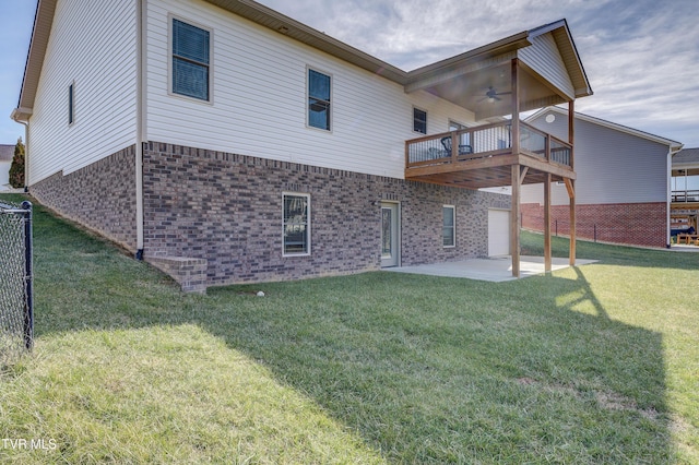 back of house with a patio area, a deck, ceiling fan, and a lawn