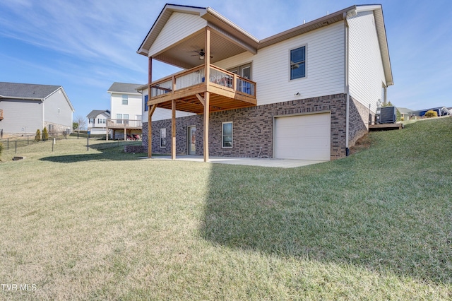 rear view of house featuring ceiling fan, a yard, and a patio