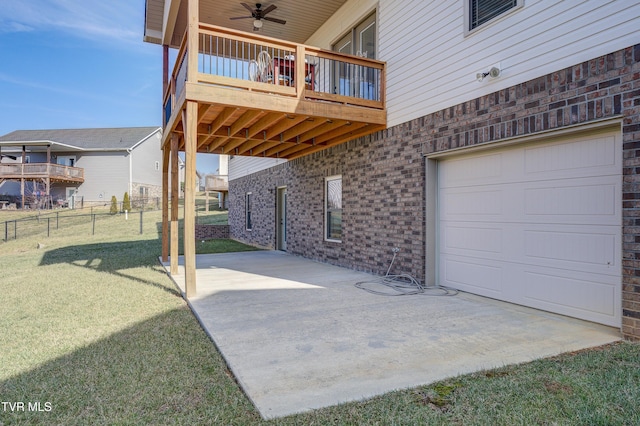 view of patio featuring a garage, a balcony, and ceiling fan