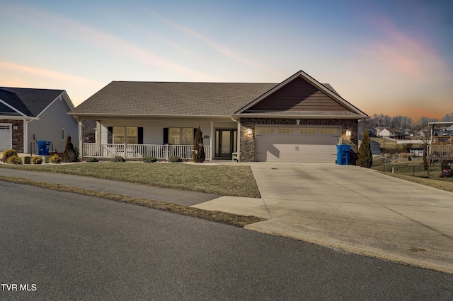 view of front facade featuring a garage and covered porch