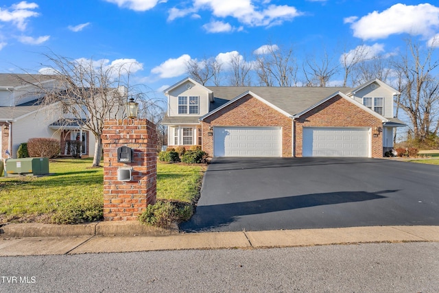 view of property with a garage and a front lawn