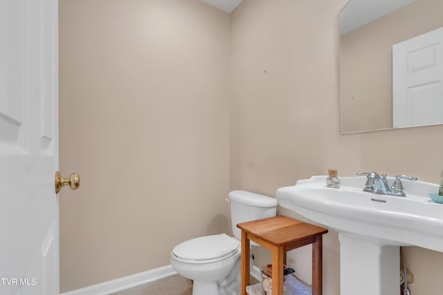 bathroom with tile patterned flooring, sink, and toilet