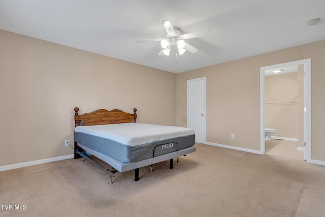 carpeted bedroom with connected bathroom, a closet, and ceiling fan