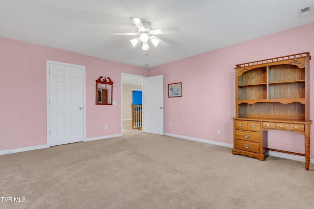 interior space featuring ceiling fan and light carpet