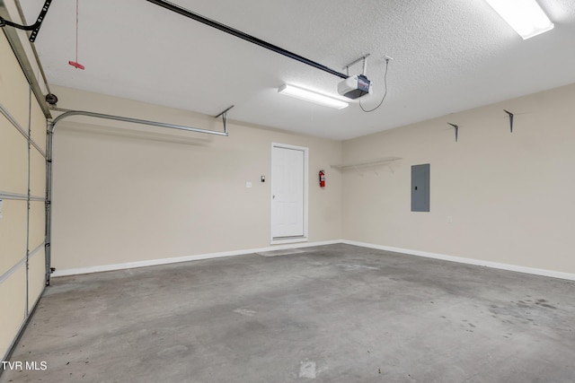 garage with a garage door opener and electric panel