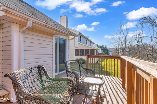 wooden terrace featuring a lawn