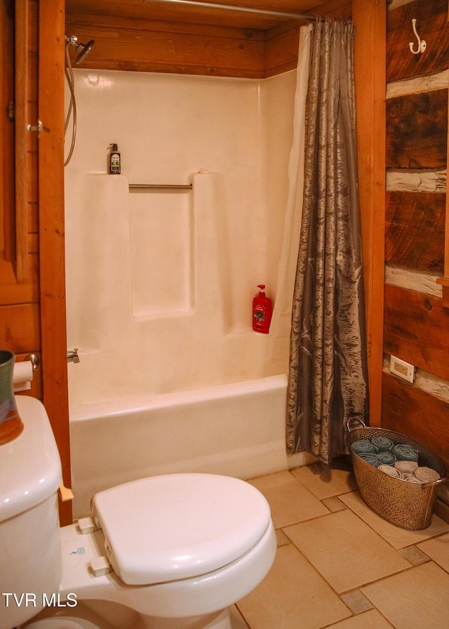 bathroom with tile patterned floors, toilet, and shower / bath combo