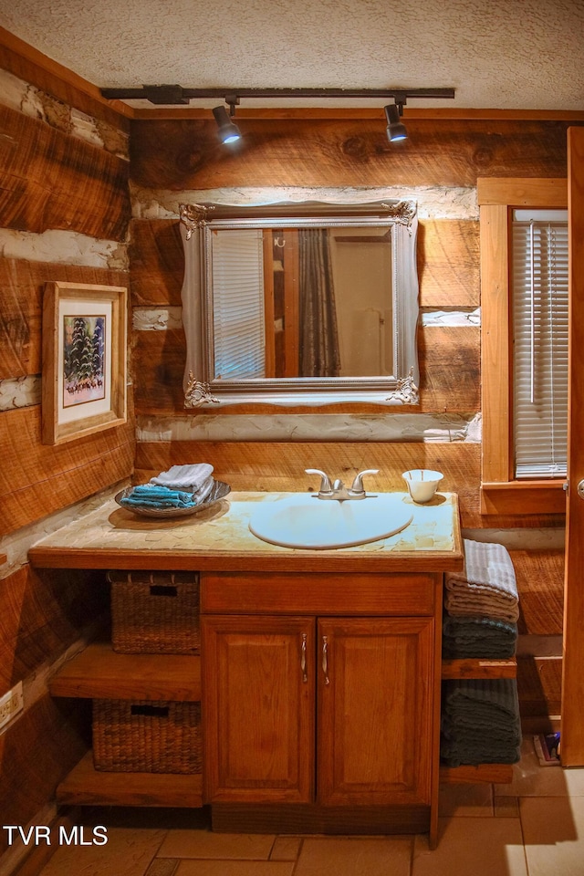 bathroom with vanity, rail lighting, and tile patterned flooring