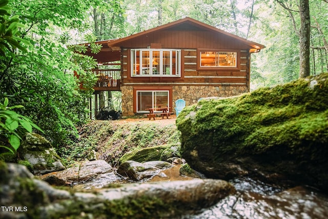 back of property featuring a deck