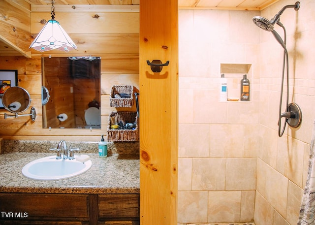 bathroom featuring vanity and tiled shower