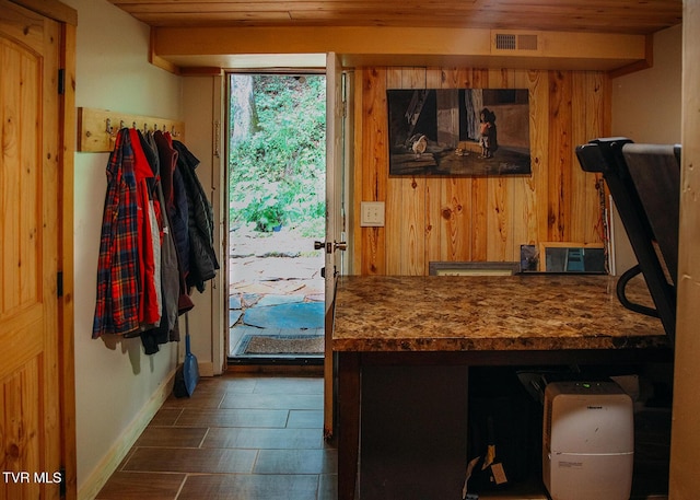 doorway to outside with wood ceiling