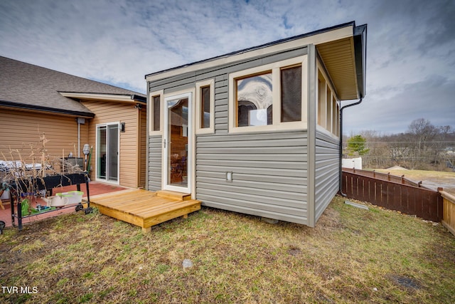 exterior space with a yard, fence, and a wooden deck