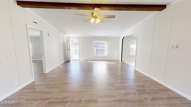 spare room featuring ornamental molding, light hardwood / wood-style floors, lofted ceiling with beams, and ceiling fan