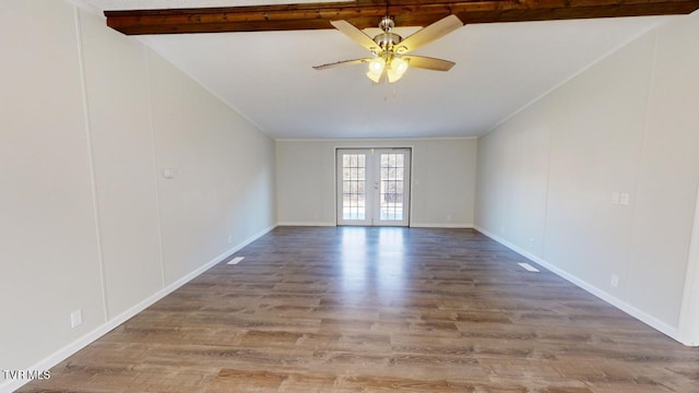 spare room with hardwood / wood-style floors, beamed ceiling, ornamental molding, ceiling fan, and french doors