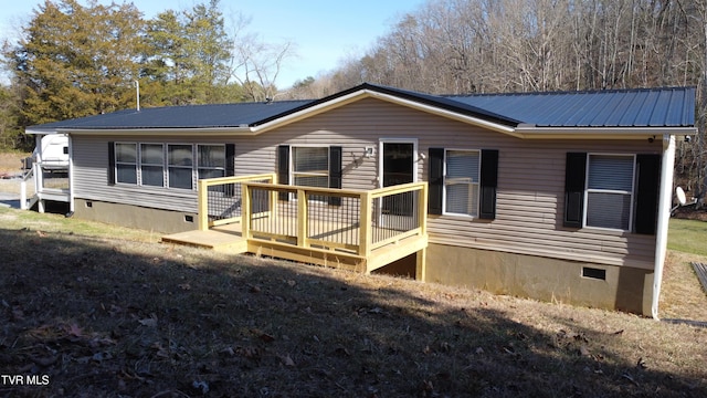 back of property with a wooden deck