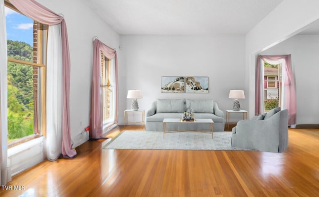 unfurnished living room with hardwood / wood-style floors and a healthy amount of sunlight