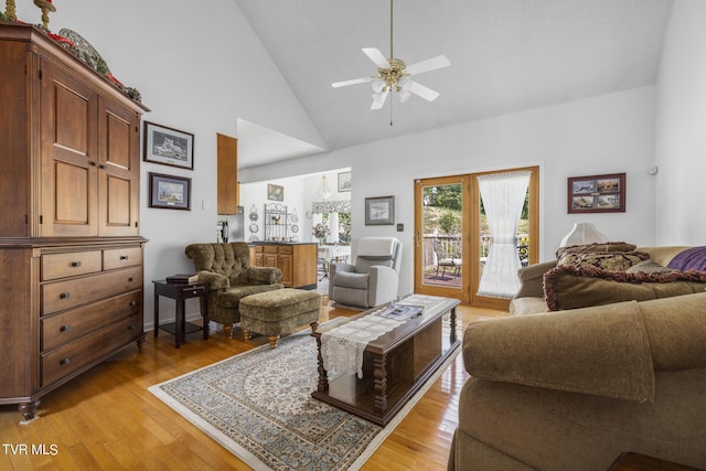 living room featuring high vaulted ceiling, light hardwood / wood-style floors, and ceiling fan