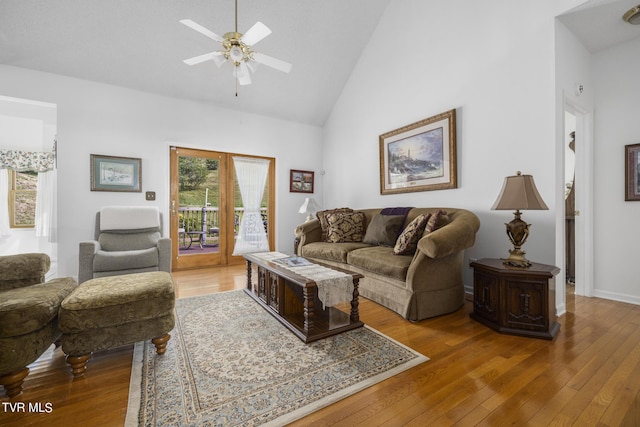 living room with french doors, ceiling fan, high vaulted ceiling, and light wood-type flooring