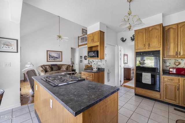 kitchen featuring pendant lighting, light tile patterned floors, black appliances, and a kitchen island