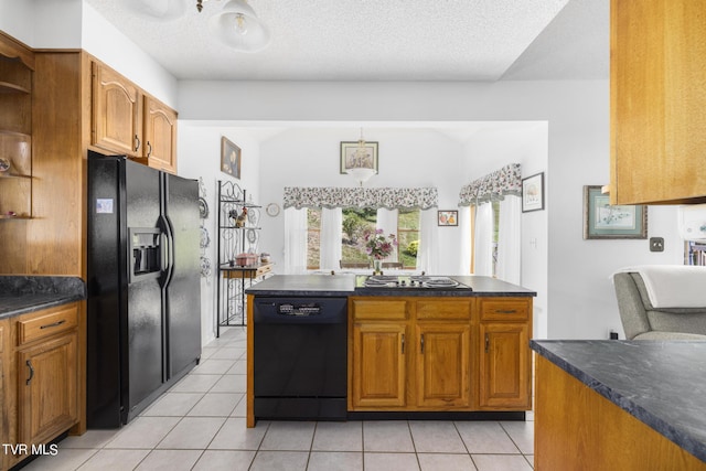 kitchen featuring black appliances, a textured ceiling, and light tile patterned flooring