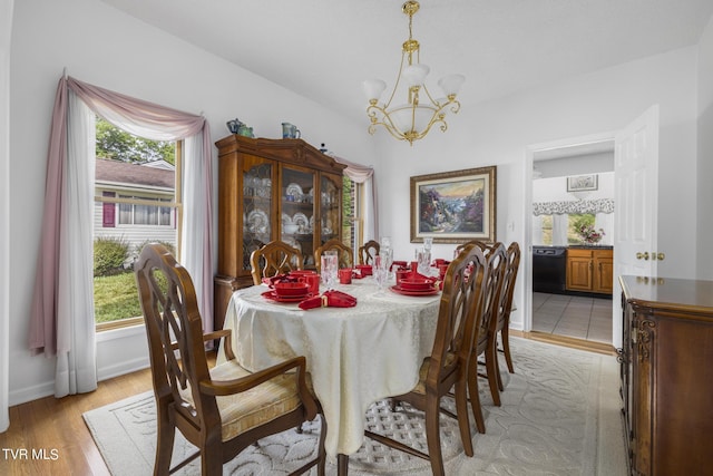 dining space featuring light hardwood / wood-style flooring and a chandelier