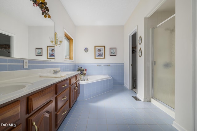 bathroom with plus walk in shower, tile patterned floors, a textured ceiling, and vanity