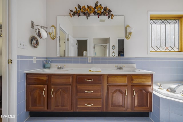 bathroom with vanity, tile patterned floors, shower with separate bathtub, and tile walls