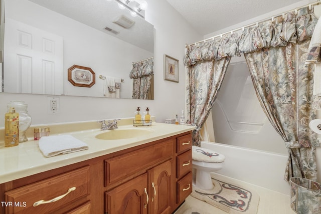 full bathroom with vanity, toilet, a textured ceiling, and shower / bath combo