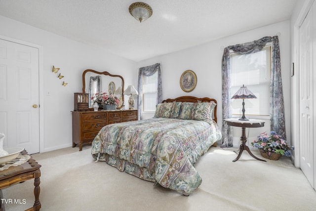 carpeted bedroom with a textured ceiling