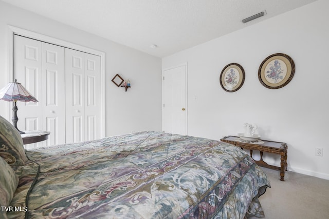 carpeted bedroom featuring a closet and a textured ceiling