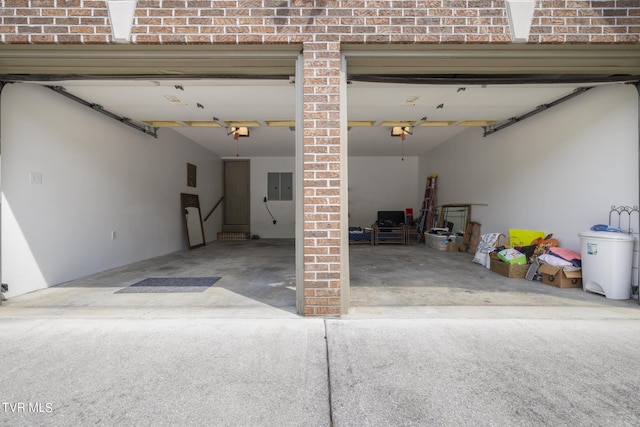 garage with a garage door opener and electric panel