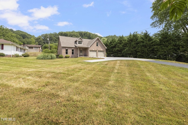 view of front of home featuring a garage and a front yard