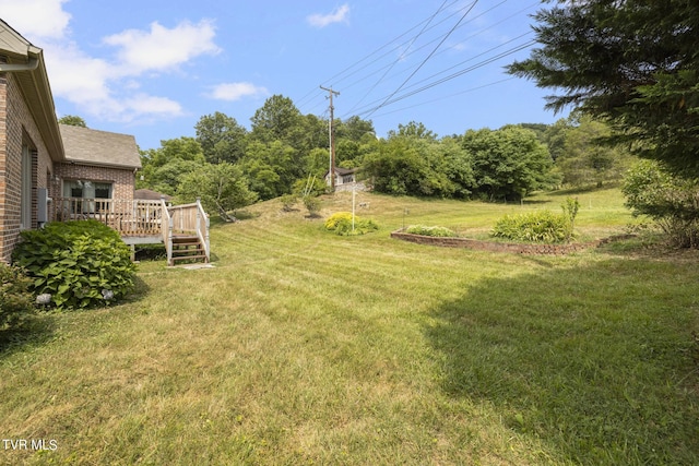 view of yard with a wooden deck