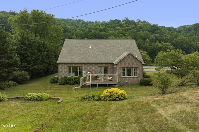 rear view of house with a yard and a deck