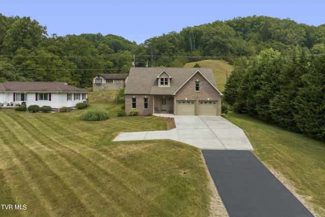 view of front of house featuring a garage and a front lawn