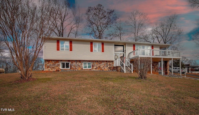 view of front of home featuring a yard and a deck