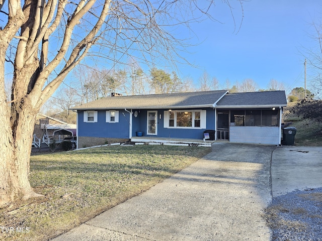 ranch-style home with a sunroom and a front lawn