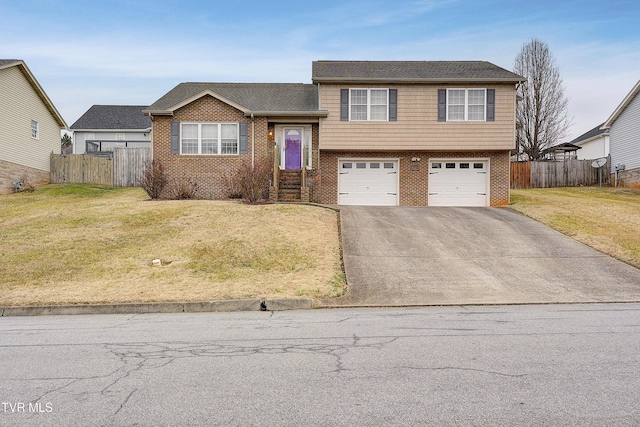 tri-level home featuring a garage and a front lawn