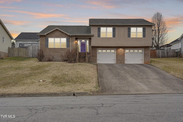 split level home featuring a yard and a garage