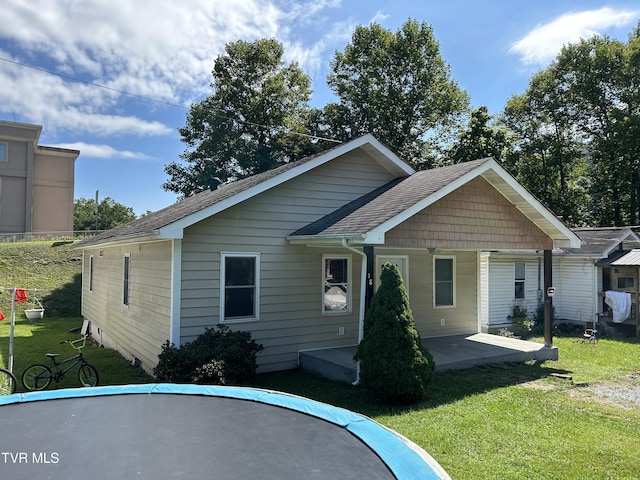 view of front of home with a front lawn and a patio