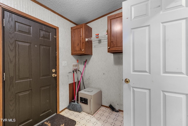 335 Clemon Rd, Whitesburg, TN 37891 - washroom featuring ornamental molding, light flooring, a textured ceiling, cabinet space, and washer hookup