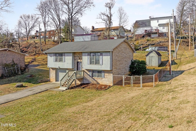 bi-level home with a storage shed, a garage, and a front lawn