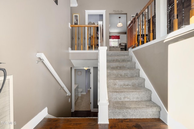 staircase with hardwood / wood-style floors