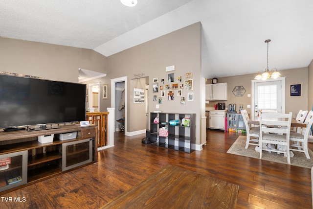 living room with vaulted ceiling, dark hardwood / wood-style flooring, and an inviting chandelier