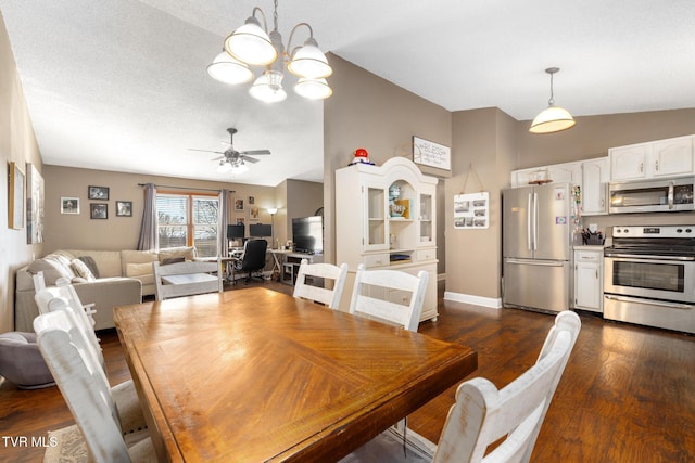 dining space with ceiling fan, lofted ceiling, dark hardwood / wood-style floors, and a textured ceiling