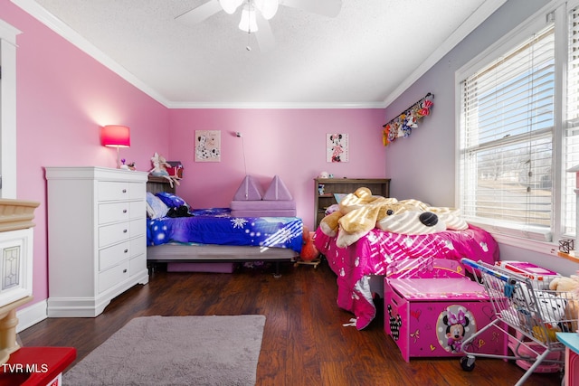 bedroom with ornamental molding, dark wood-type flooring, ceiling fan, and a textured ceiling