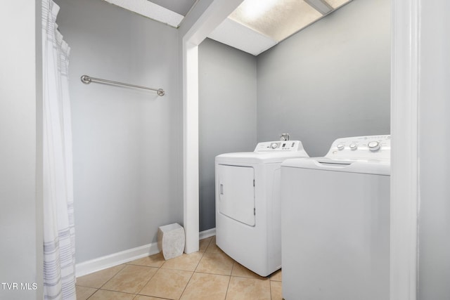 washroom with light tile patterned flooring and independent washer and dryer